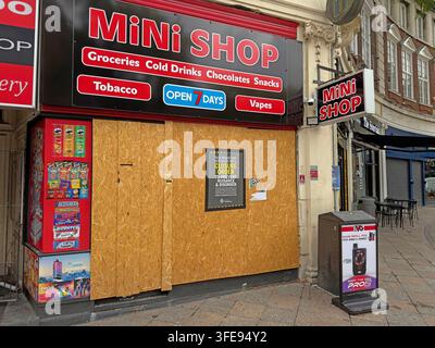 Police Closure Order on a boarded Warrington convenience store, reflecting action against illicit tobacco, illegal vapes and antisocial behaviour. Stock Photo