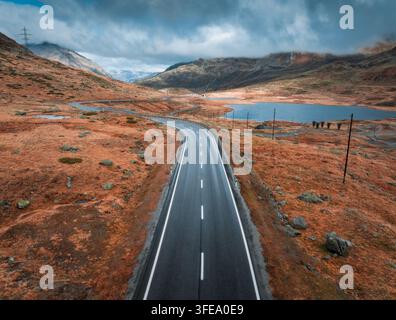Aerial view of a winding mountain road with sharp hairpin bends ...