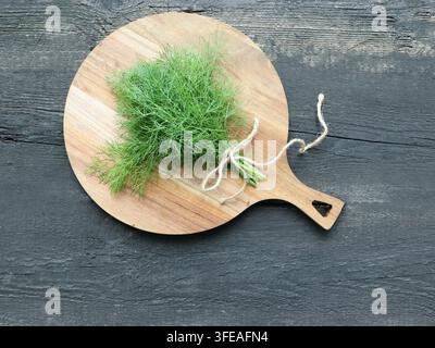 Fresh Dill Bunch on Wooden Cutting Board Stock Photo
