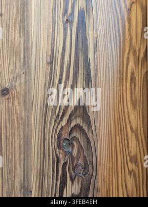 Pirovac, Kroatien August 16, 2026 Close view of weathered wooden plank surface showing rich grain lines, dark knots, and warm brown tones, with wood, Stock Photo