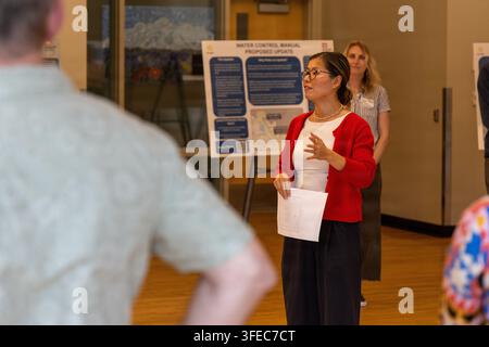 Connie Chow, a U.S. Army Corps of Engineers employee, speaks at a public open house for the Mud Mountain Dam Water Control Manual update at the Auburn Community & Event Center in Auburn, Washington, on September 1, 2026, regarding proposed changes to water-management decisions using data from a White River gauge. Stock Photo