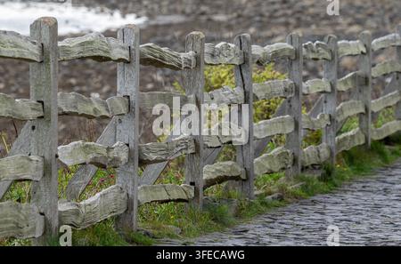 Old rustic wooden fence and sone path Stock Photo