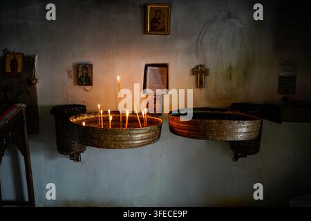 Lit Prayer Candles In Copper Stand Inside Agia Paraskevi Monastery In Monodendri Epirus Greece Stock Photo