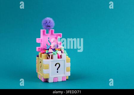 Afraid of so much love, a cube with a question mark filled with colorful hearts Stock Photo