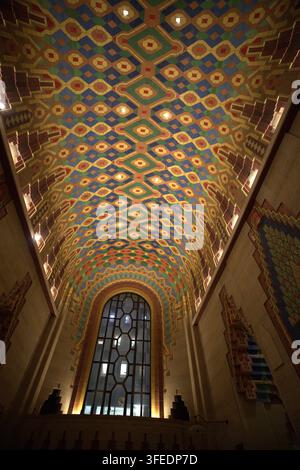 Low-angle view of a magnificent Art Deco vaulted ceiling featuring vibrant geometric tile mosaics and intricate decorative details in a historic inter Stock Photo