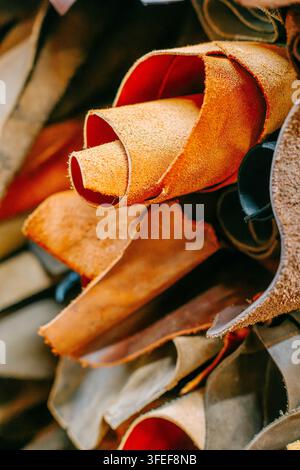 Textured leather sheets overlap in natural brown and beige tones, revealing detailed surfaces and edges. Stock Photo