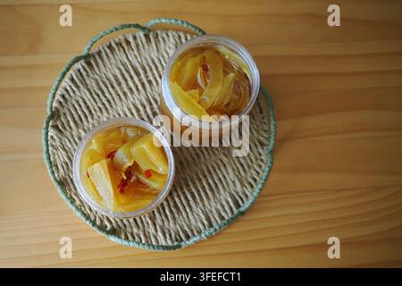 show small plastic jars filled with homemade fruit preserves or jam, Stock Photo