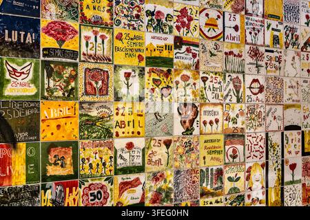 Decorative Tiled Wall in Chiado, Lisbon. A colorful patchwork of hand-painted ceramic tiles creates a vibrant urban art display. Stock Photo