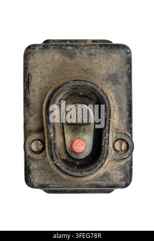 An old switch with a Start button. An old dirty switch on a white background. Powerful electrical switch. Stock Photo