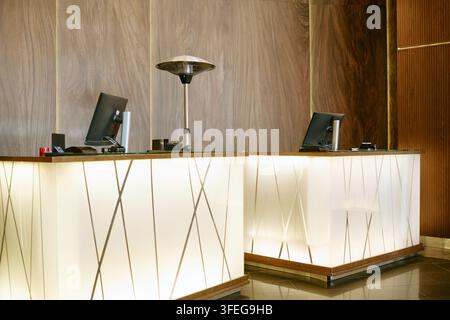 Empty Luxury Hotel Reception Desks in Modern Hospitality Lobby Stock Photo