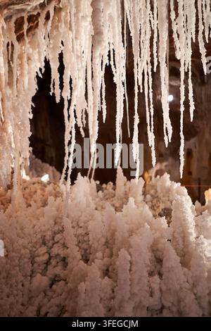 Stunning view inside a salt mine, showcasing unique formations of salt stalactites and stalagmites, creating a surreal, natural landscape. Stock Photo
