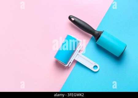 Different lint rollers on color background Stock Photo