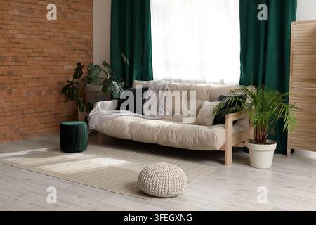 Comfortable sofa near window with green curtains in living room Stock Photo