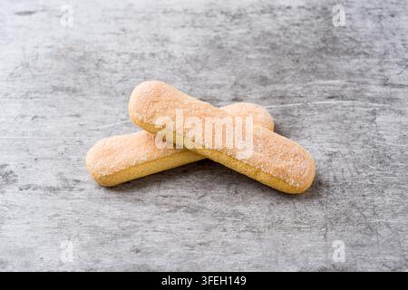 Savoiardi ladyfinger biscuits arranged crosswise on textured gray background Stock Photo