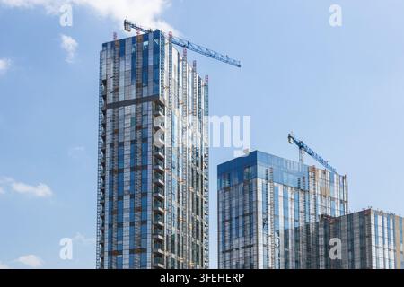 High rise residential buildings under construction with tower cranes Stock Photo