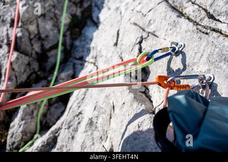 Improperly rigged multi pitch climbing belay station with a clove hitch on one anchor and no connection between two bolt anchors, illustrating anchor Stock Photo