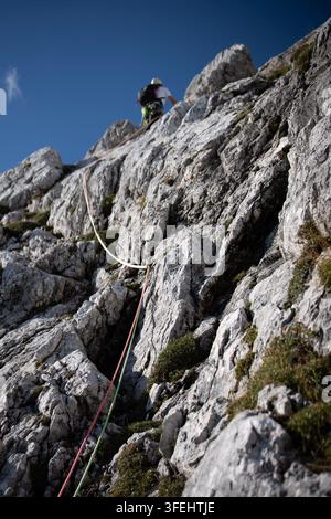 Improperly rigged multi pitch climbing belay station with a clove hitch on one anchor and no connection between two bolt anchors, illustrating anchor Stock Photo