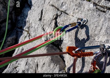 Improperly rigged multi pitch climbing belay station with a clove hitch on one anchor and no connection between two bolt anchors, illustrating anchor Stock Photo
