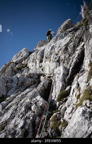 Improperly rigged multi pitch climbing belay station with a clove hitch on one anchor and no connection between two bolt anchors, illustrating anchor Stock Photo