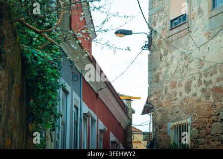 Porto, Portugal - 2024.03.16. 16:14: A low-angle view looking down a narrow, atmospheric European alleyway, highlighting the rich textures and contras Stock Photo