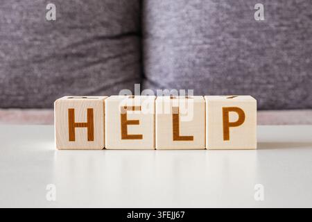 motivational word Help is laid out from letters on wooden cubes Stock Photo