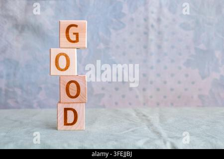 motivational word Good is laid out from letters on wooden cubes Stock Photo
