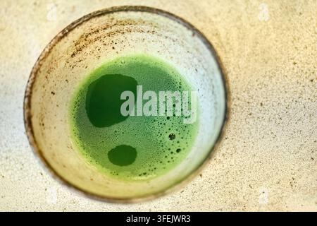 Matcha green tea in ceramic bowl preparing healthy drink Stock Photo