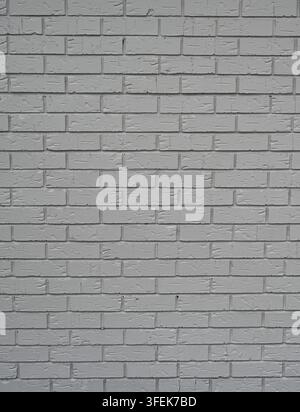 Gray painted textured brick and mortar wall surface in vertical close-up, showing standard brick pattern, porous recessed mortar Stock Photo
