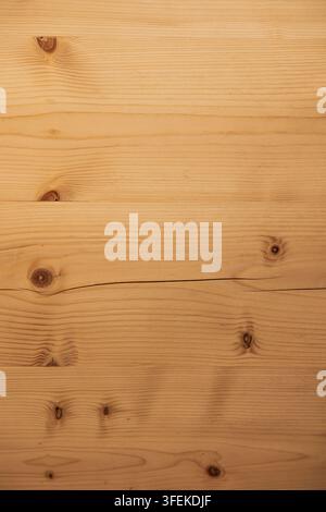 Surface of wooden boards with pronounced grain and a warm amber tone, likely spruce or pine, characteristic of sauna and wellness center interior desi Stock Photo