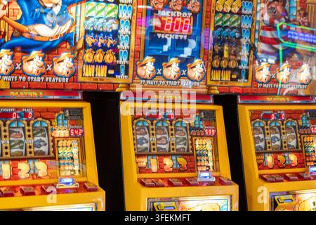 Fruit machines in brightly coloured designs at an amusement arcade at the seaside in Sandwon on the isle of wight. Stock Photo