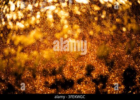 Golden luxury gold texture in artistic design. Golden nano surface on metallic foil. Golden glowing wallpaper for cosmetic branding. Golden glittering Stock Photo