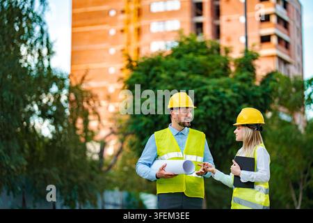 Engineers and architect discussing construction project outdoors Stock Photo