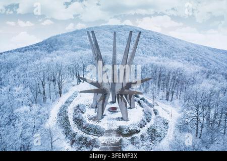 January 3, 2026, Kosmaj, Serbia: Drone aerial of the socialist-era star-shaped concrete Kosmaj Monument surrounded by frost-covered forest on a snow-b Stock Photo