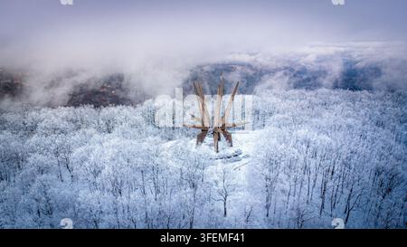 January 3, 2026, Sopot, Serbia: Star-shaped Kosmaj Monument rises above frost-white forest canopy in winter mist Stock Photo