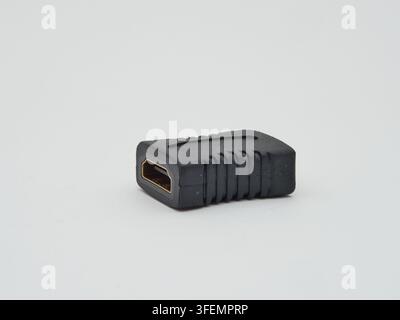 HDMI Adapter Coupler on White Background - A black HDMI adapter coupler with a gold-plated connector is isolated on a clean white background, ready fo Stock Photo