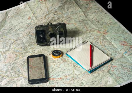 Trail camera scouting equipment on topographic map for exploration Stock Photo