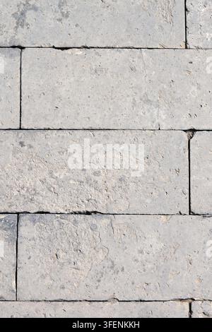 Light Gray Limestone Block Wall Texture with Natural Stone Pattern and Weathered Surface Stock Photo