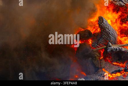 Emergency workers clear debris and damaged road infrastructure near a ...