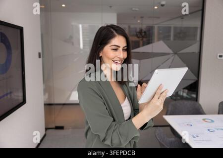 Happy woman using digital tools on tablet for strategic planning Stock Photo