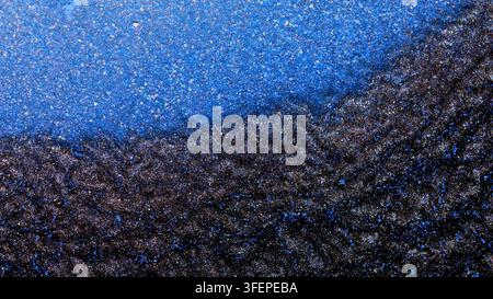 Mixing alcohol ink creates colorful patterns in a close-up view Stock Photo