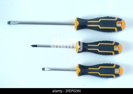 Assorted Screwdrivers on White Background Top View Stock Photo
