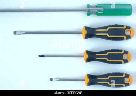 Assorted Screwdrivers on White Background Top View Stock Photo