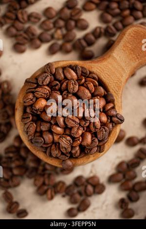 Roasted coffee beans in rustic wooden scoop Stock Photo