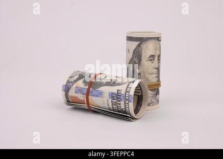 Rolled American dollars banknotes. Bundle of money roll of dollars isolated on white background, with clipping path. Stock Photo