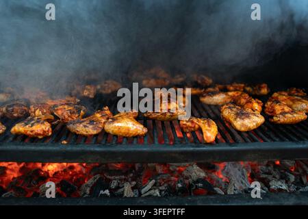Delicious BBQ Chicken Wings Cooking on an Outdoor Charcoal Grill Stock Photo