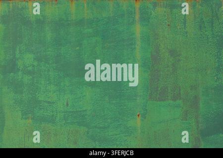 Close-up view of a weathered green metal surface showing rust and chipped paint. Textured background ideal for grungy or industrial designs. Stock Photo