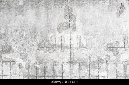 Old crumbling concrete wall revealing rusty rebar and decaying urban texture Stock Photo