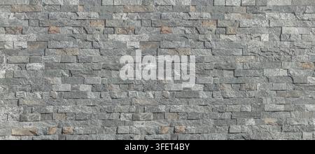 Layered grey slate stone wall presenting a rustic surface texture Stock Photo