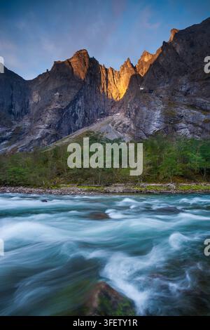 Early morning golden hour sunlight on The Troll Wall, Rauma kommune, Møre og Romsdal, Norway. Stock Photo