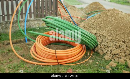 Coiled fiber optic optical cables internet networks silica glass fiber laying copper prepared underground internet telecommunications installation Stock Photo